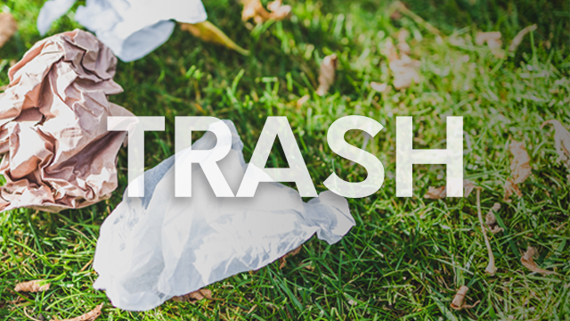 litter on the ground with the word trash